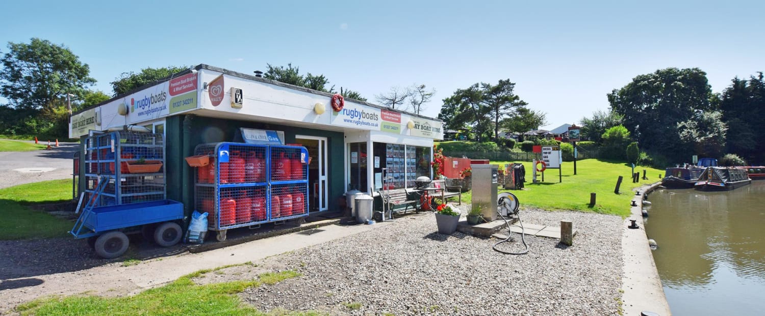 Rugby Boats canal-side wharf office with gas cylinder storage